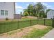 View of backyard and lawn area featuring a dark metal fence and view of surrounding landscape at 1914 Carovel Way, Kennesaw, GA 30144