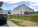 View of backyard with fence and patio area in a community of townhomes with tidy landscaping at 1914 Carovel Way, Kennesaw, GA 30144