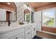 Stylish bathroom with double vanity, modern mirrors, and plenty of natural light at 1914 Carovel Way, Kennesaw, GA 30144
