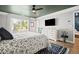 Bright bedroom with large windows, white dresser, ceiling fan, and en-suite bath at 1914 Carovel Way, Kennesaw, GA 30144