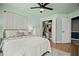 Bright bedroom with a bed, ceiling fan, and closet with organized clothing at 1914 Carovel Way, Kennesaw, GA 30144