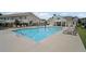 View of the community pool, surrounded by lounge chairs, umbrellas, and common areas at 1914 Carovel Way, Kennesaw, GA 30144