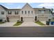 Townhome exteriors feature varied colors, brick accents, driveways, and attached garages at 1914 Carovel Way, Kennesaw, GA 30144