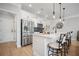 Bright kitchen features white cabinetry, stainless steel appliances, and bar seating at 1914 Carovel Way, Kennesaw, GA 30144