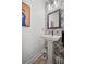 Charming powder room featuring a pedestal sink and stylish peacock-themed wallpaper at 1914 Carovel Way, Kennesaw, GA 30144