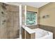 Bathroom featuring a separate bathtub, shower with glass doors, and tile surround at 3461 Dianthus Ln, Lawrenceville, GA 30044