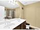 Bathroom featuring double sink vanity and shower with glass doors at 3461 Dianthus Ln, Lawrenceville, GA 30044