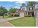View of townhomes with landscaped front yards and attached garages at 3461 Dianthus Ln, Lawrenceville, GA 30044