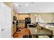 Bright kitchen with wooden cabinets, granite counters, and stainless steel appliances at 3461 Dianthus Ln, Lawrenceville, GA 30044