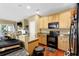 Kitchen with granite countertops and wooden cabinets adjacent to living area at 3461 Dianthus Ln, Lawrenceville, GA 30044