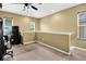 Spacious loft area with carpet flooring, natural light, and a ceiling fan at 3461 Dianthus Ln, Lawrenceville, GA 30044
