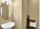 Small powder room featuring a pedestal sink and a decorative mirror at 3461 Dianthus Ln, Lawrenceville, GA 30044