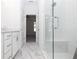 Bathroom with white cabinets, double vanity, and glass enclosed shower with a seat at 354 Olmstead Way # 27, Alpharetta, GA 30022