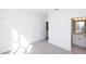 Bright bedroom with gray carpet, white walls, and a view to the bathroom at 354 Olmstead Way # 27, Alpharetta, GA 30022
