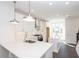 Bright kitchen with stainless steel appliances, island, and white cabinets at 354 Olmstead Way # 27, Alpharetta, GA 30022