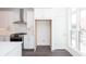 Bright kitchen with white cabinetry, stainless steel range, and window providing natural light at 354 Olmstead Way # 27, Alpharetta, GA 30022
