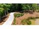 Picturesque walking path winding through lush greenery and a tranquil pond at 354 Olmstead Way # 27, Alpharetta, GA 30022