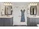 Dual sinks with framed mirrors, vanity storage and door with decor in renovated bathroom at 406 Genevieve Dr, Canton, GA 30114