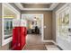 Inviting entryway with a unique vintage Coca-Cola refrigerator and views into the home office at 406 Genevieve Dr, Canton, GA 30114