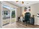 Bright home office featuring a desk, ceiling fan, and sliding glass door to the pool area at 406 Genevieve Dr, Canton, GA 30114