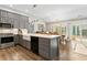 Well-equipped kitchen with stainless steel appliances, gray cabinets, stone countertops and a view of the backyard at 406 Genevieve Dr, Canton, GA 30114