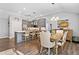 Bright kitchen and dining area featuring stainless steel appliances, modern lighting, and an island with barstool seating at 406 Genevieve Dr, Canton, GA 30114