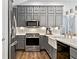 Modern kitchen with stainless steel appliances, sleek gray cabinetry, and a farmhouse sink for added charm at 406 Genevieve Dr, Canton, GA 30114