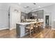 Modern kitchen with stainless steel appliances, a center island with seating, and stylish pendant lighting at 406 Genevieve Dr, Canton, GA 30114