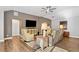 Spacious living room with hardwood floors, a ceiling fan, and comfortable leather seating at 406 Genevieve Dr, Canton, GA 30114