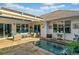 Inviting outdoor patio featuring stone pavers, a small pool, cozy seating and partial awning at 406 Genevieve Dr, Canton, GA 30114