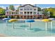 A view of the pool area with water features, with the clubhouse in the background, perfect for summer relaxation at 406 Genevieve Dr, Canton, GA 30114