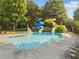 A view of the pool area with water slides and lounge chairs, showcasing a fun and relaxing community space at 406 Genevieve Dr, Canton, GA 30114