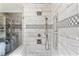 Modern shower featuring glass enclosure, rainfall shower head, built in shelving and decorative tile accent wall at 406 Genevieve Dr, Canton, GA 30114