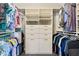Custom walk-in closet offering ample hanging and shelf space with central drawer and shelving unit at 406 Genevieve Dr, Canton, GA 30114
