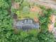 Overhead view of the roof on the home, nestled on a well-manicured lawn with mature trees and landscaping at 1050 Birdseye Vw, Locust Grove, GA 30248