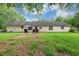 View of the backyard featuring a small patio set, lush grass, and a grill at 1050 Birdseye Vw, Locust Grove, GA 30248