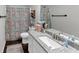 Bathroom featuring granite countertops, shower with patterned curtain, and a dark wood floor at 1050 Birdseye Vw, Locust Grove, GA 30248