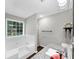 Bright bathroom features a garden tub with jets, granite countertop, vanity and large window at 1050 Birdseye Vw, Locust Grove, GA 30248