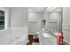Spacious bathroom featuring a garden tub with jets, granite countertop, vanity and large window at 1050 Birdseye Vw, Locust Grove, GA 30248