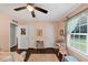 Bedroom featuring a large window, ceiling fan, pink walls, and wood flooring at 1050 Birdseye Vw, Locust Grove, GA 30248