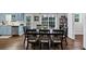 Dining room features hardwood floors, large windows, and seamless transition to kitchen at 1050 Birdseye Vw, Locust Grove, GA 30248