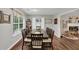 Bright dining space with hardwood floors leads to a cozy living room and functional kitchen at 1050 Birdseye Vw, Locust Grove, GA 30248