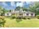 Inviting single-Gathering home with a well-maintained lawn, mature trees, and a welcoming front porch at 1050 Birdseye Vw, Locust Grove, GA 30248