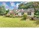 Charming single-Gathering home featuring a lush green lawn, mature trees, and classic curb appeal at 1050 Birdseye Vw, Locust Grove, GA 30248