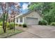 Side view of a single-Gathering home, highlighting an attached garage and well-kept landscaping at 1050 Birdseye Vw, Locust Grove, GA 30248
