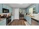 Well-lit kitchen features granite counters, stainless steel appliances, and hardwood floors at 1050 Birdseye Vw, Locust Grove, GA 30248