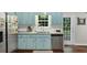 Bright kitchen featuring stainless steel appliances, light blue cabinets, granite countertops, and wood flooring at 1050 Birdseye Vw, Locust Grove, GA 30248