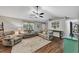 Inviting living room featuring hardwood floors, ceiling fan, and plush seating at 1050 Birdseye Vw, Locust Grove, GA 30248