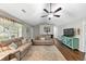Comfortable living room with neutral tones, ceiling fan, hardwood floors, and ample seating at 1050 Birdseye Vw, Locust Grove, GA 30248