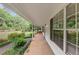 Inviting covered porch with white pillars and view of the front yard landscaping at 1050 Birdseye Vw, Locust Grove, GA 30248